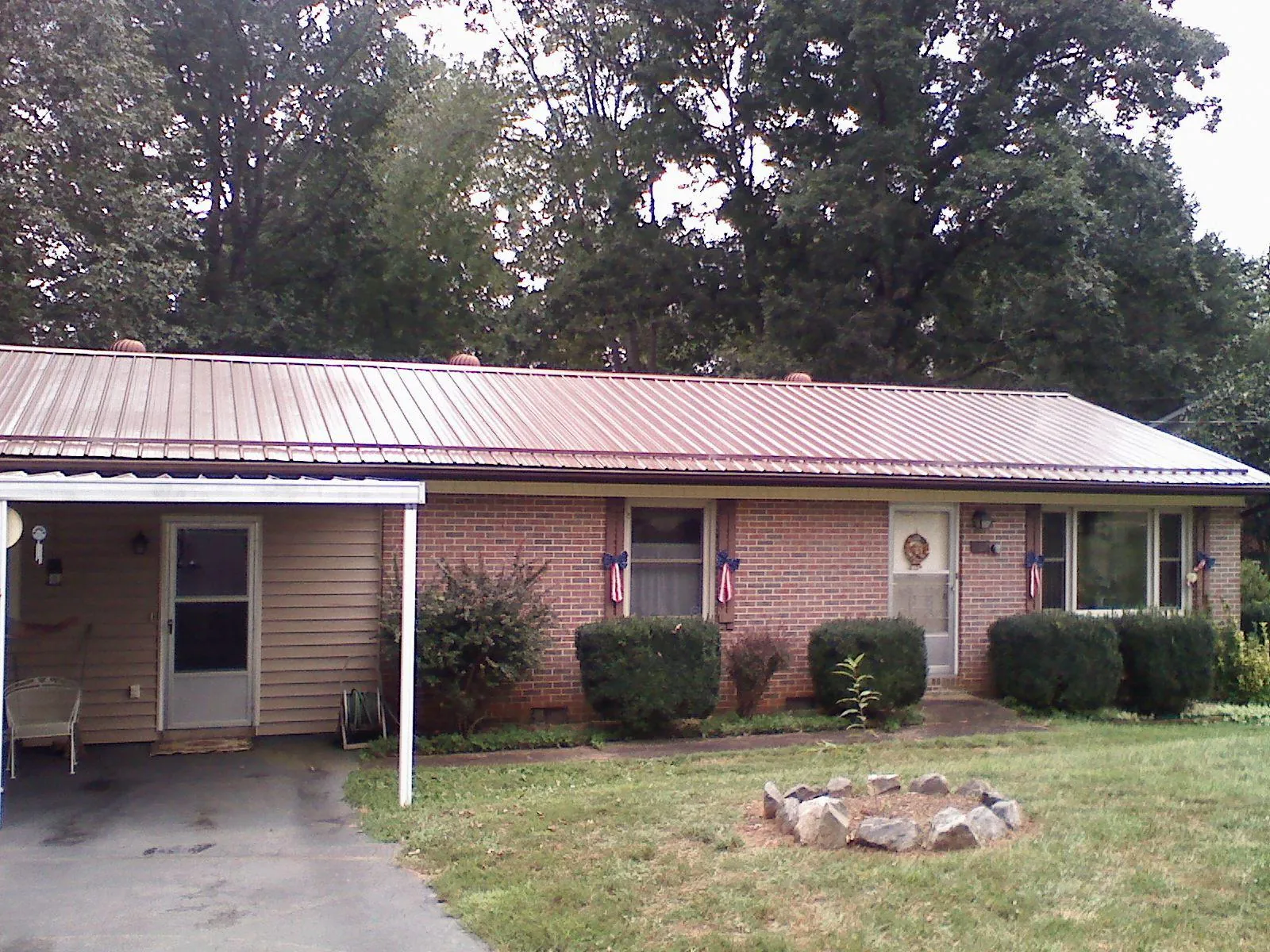Bronze metal roof and carport on a brick ranch home — Roof Repair work by our crew in Fort Lawn