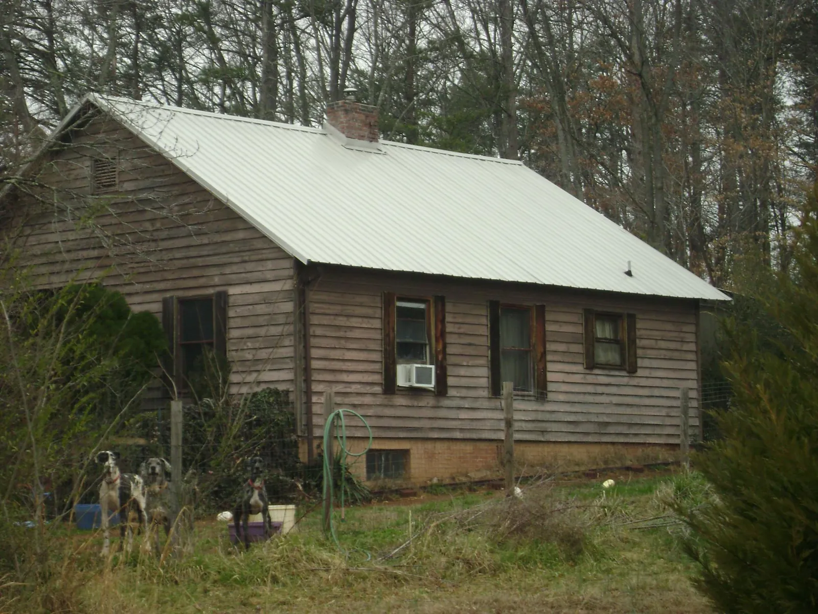 White metal roof on an old wood sided farmhouse, from a Metal Roof Installation job in Fort Lawn